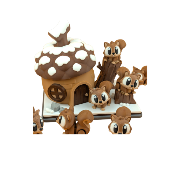 3D printed squirrel figurine with articulated flexi body beside matching acorn house decor